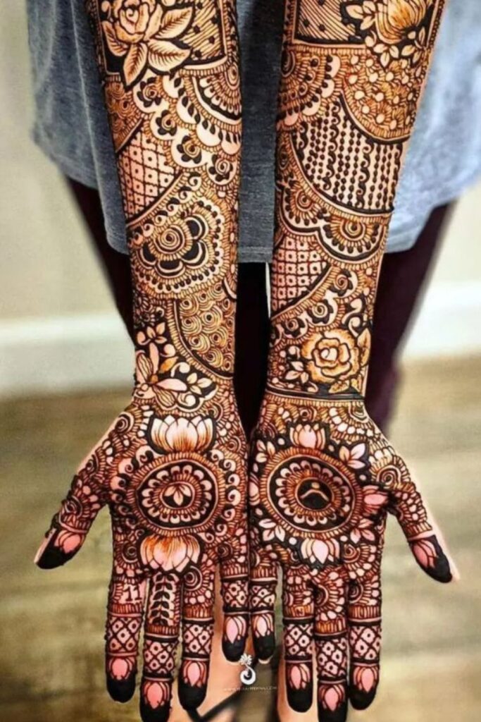 Front hand heavy bridal mehndi design with a combination of rose and lotus floral design