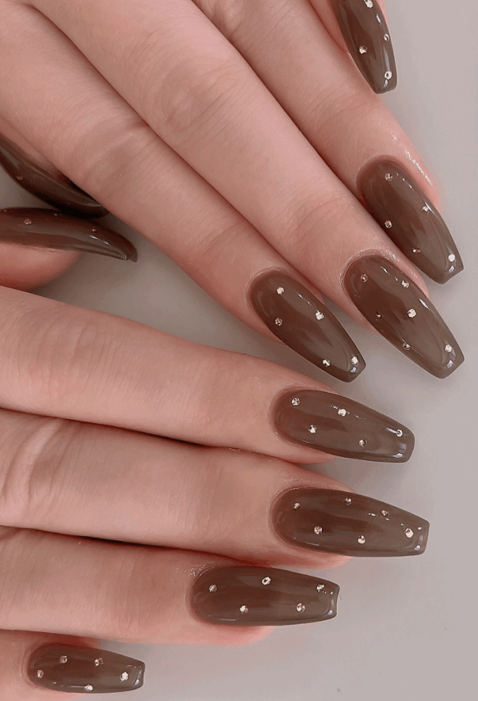 Chrome nails or glass nails in jewel tones are the latest trends in fall 2025